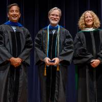 Faculty posing with award with Robert Smart and the Provost